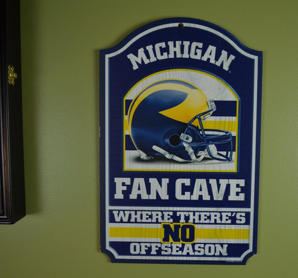 WinCraft Collegiate Fan Shop Authentic NCAA Fan Cave Wooden Sign. Stake Your Territory with This Sign. For the Office or Man Cave. This 11"X17" Sign Let's Everyone Know Your Team